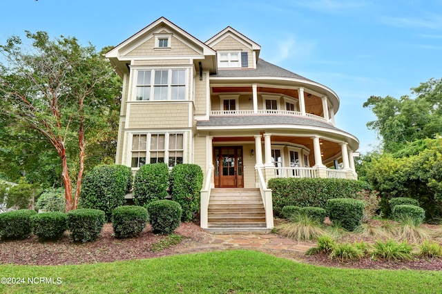 view of front of home with a balcony and covered porch