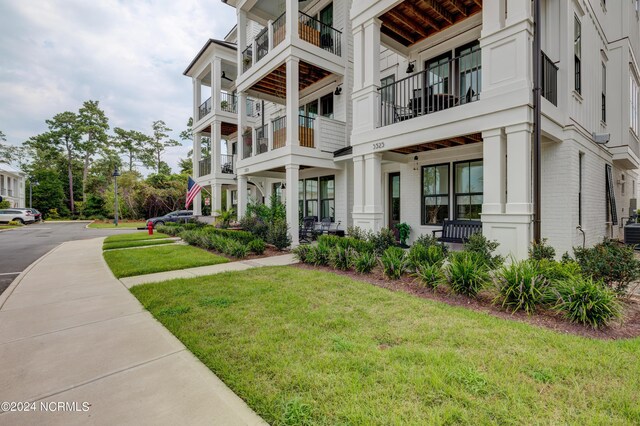 exterior space with a front yard and brick siding