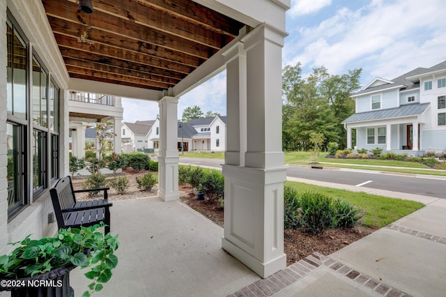 view of patio / terrace with a residential view and covered porch