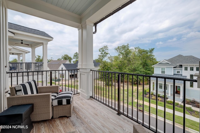 balcony with an outdoor hangout area and a residential view