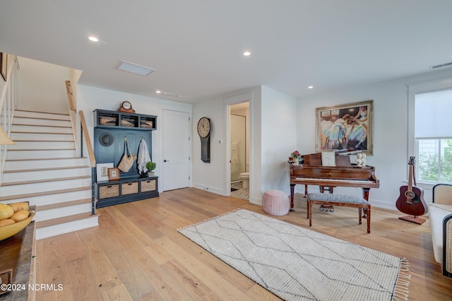 entrance foyer featuring baseboards, stairway, light wood-style flooring, and recessed lighting