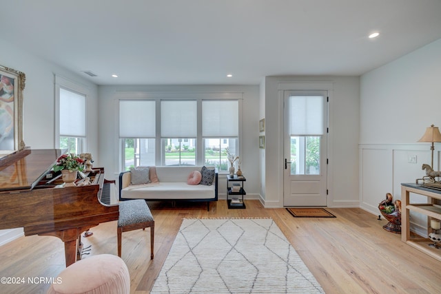 living room featuring light wood-type flooring, visible vents, and recessed lighting