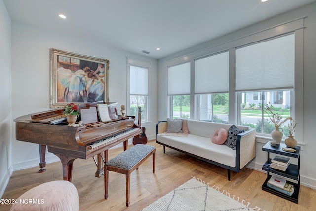 sitting room featuring baseboards, light wood finished floors, visible vents, and recessed lighting