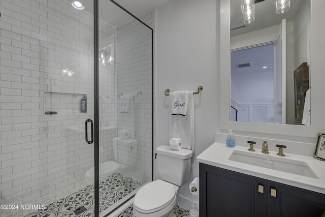 full bathroom featuring visible vents, a shower stall, toilet, and vanity