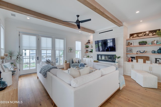 living room featuring recessed lighting, a fireplace, visible vents, beam ceiling, and light wood finished floors