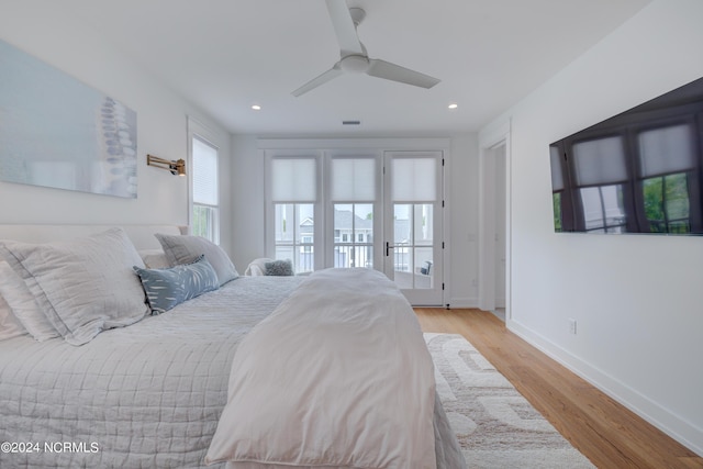 bedroom with access to outside, light wood finished floors, a ceiling fan, and baseboards