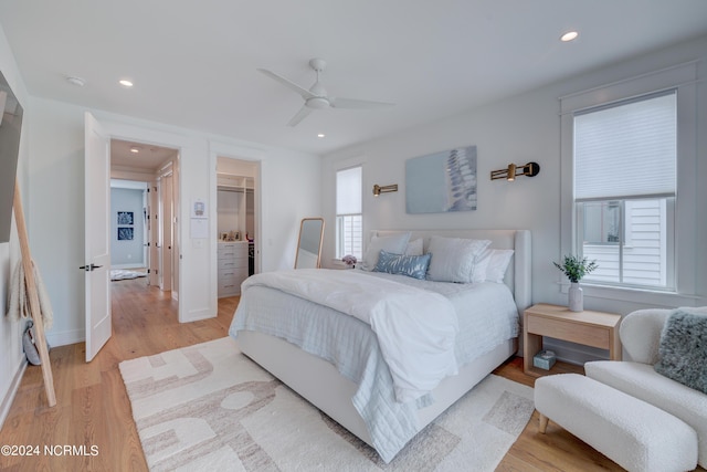 bedroom featuring light wood-style flooring, recessed lighting, a ceiling fan, a spacious closet, and a closet