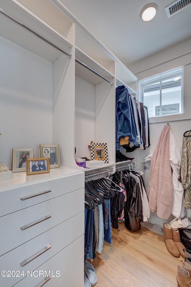 spacious closet featuring light wood finished floors and visible vents