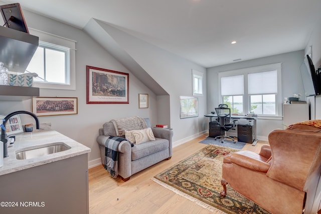 living area featuring light wood-style floors, baseboards, and recessed lighting