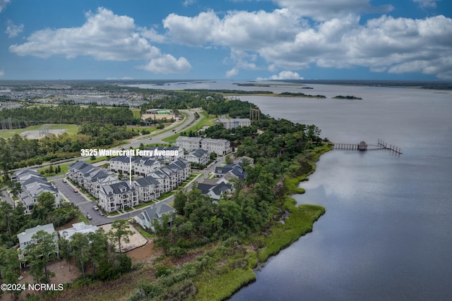 drone / aerial view with a water view and a residential view