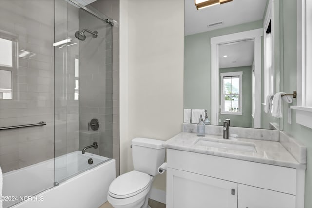 full bathroom with toilet, enclosed tub / shower combo, visible vents, and vanity