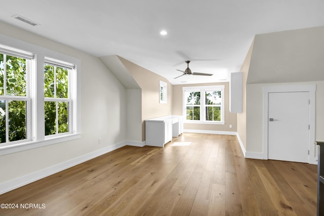 additional living space with baseboards, a ceiling fan, visible vents, and light wood-style floors