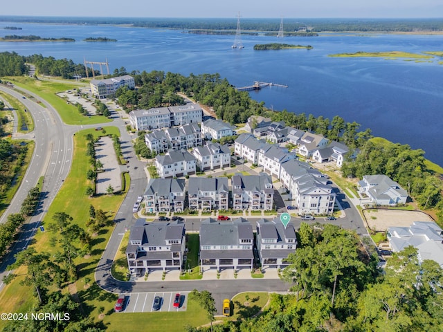 drone / aerial view with a water view and a residential view