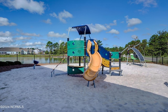 community playground featuring a water view and fence