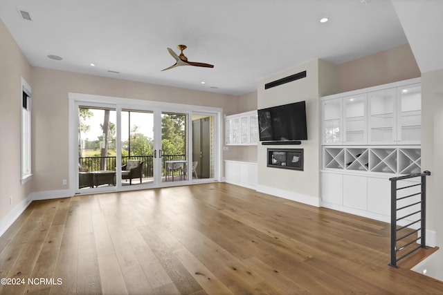 unfurnished living room with recessed lighting, ceiling fan, baseboards, and wood finished floors