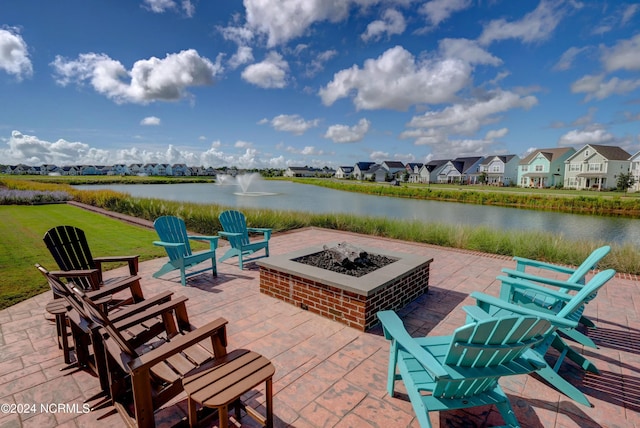 view of patio with a water view, an outdoor fire pit, and a residential view