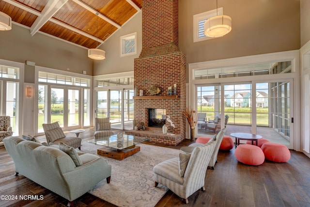 living room with wooden ceiling, a fireplace, a wealth of natural light, and wood finished floors