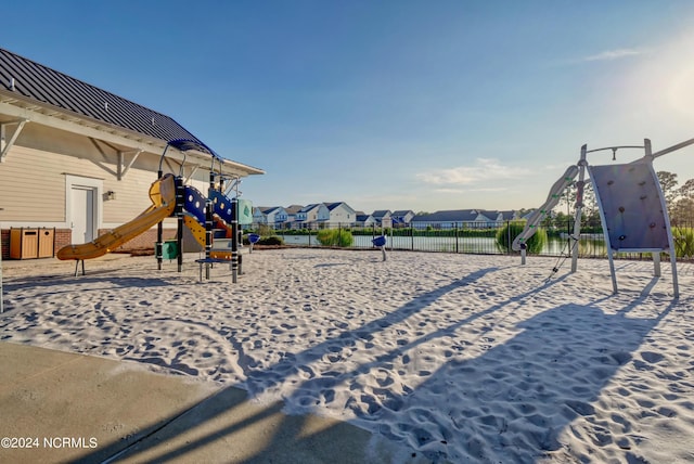 community playground featuring volleyball court, fence, and a residential view