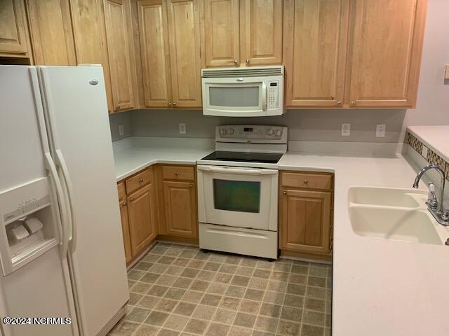 kitchen with white appliances and sink