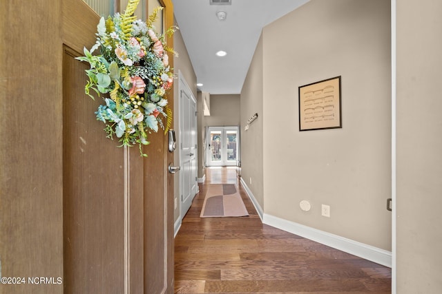 corridor featuring french doors, recessed lighting, wood finished floors, and baseboards