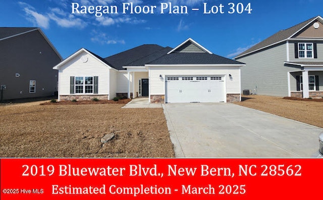 view of front facade with a front lawn, stone siding, concrete driveway, an attached garage, and central AC unit