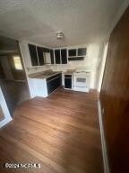 unfurnished living room featuring hardwood / wood-style flooring