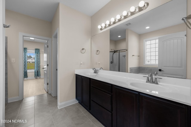 bathroom with vanity, walk in shower, and tile patterned flooring