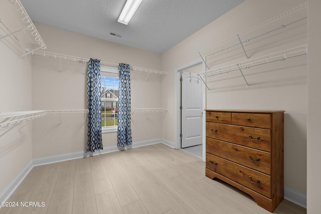 walk in closet featuring light wood-type flooring