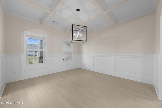 unfurnished dining area with coffered ceiling, beam ceiling, light hardwood / wood-style flooring, ornamental molding, and a notable chandelier