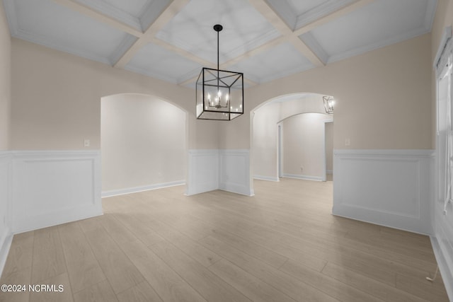 interior space featuring coffered ceiling, beamed ceiling, and light hardwood / wood-style flooring