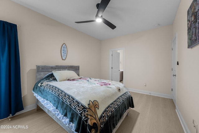 bedroom featuring hardwood / wood-style flooring, ensuite bath, and ceiling fan