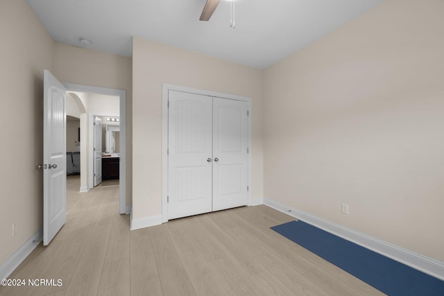 unfurnished bedroom with a closet, ceiling fan, and light hardwood / wood-style flooring