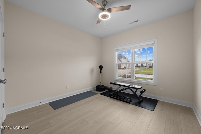 workout room featuring light hardwood / wood-style flooring and ceiling fan