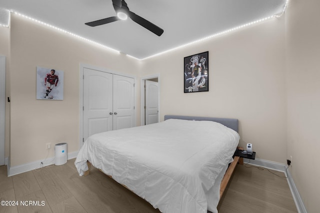 bedroom with a closet, ceiling fan, and hardwood / wood-style floors