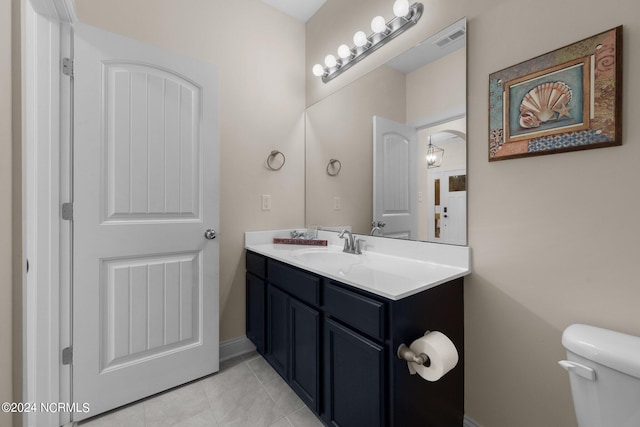 bathroom featuring toilet, vanity, and tile patterned floors