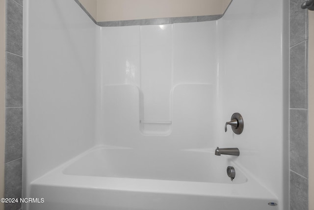 bathroom with bathing tub / shower combination