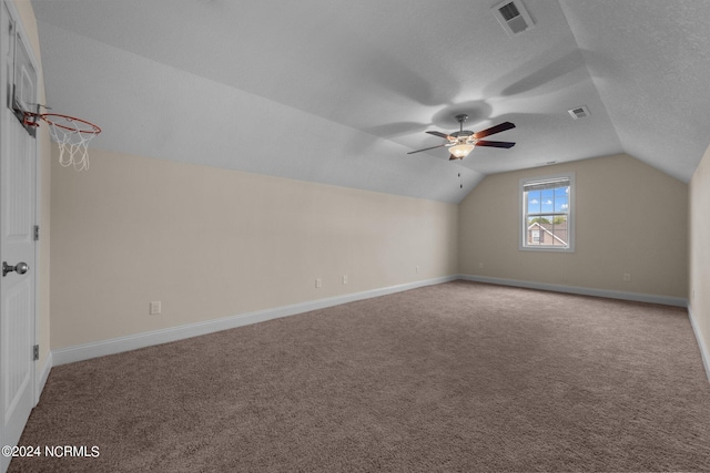 bonus room featuring ceiling fan, a textured ceiling, vaulted ceiling, and carpet floors