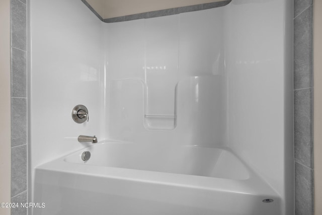 bathroom with bathing tub / shower combination