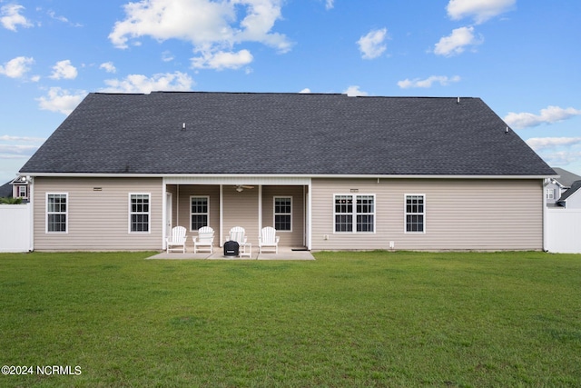 back of house featuring a patio, ceiling fan, and a yard