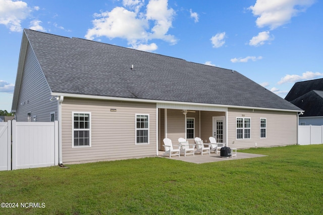 back of property featuring a patio, a yard, and ceiling fan