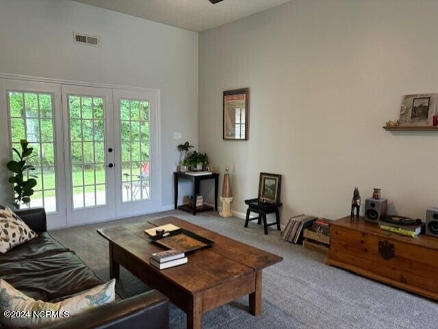 living room featuring french doors, ceiling fan, carpet, and a wealth of natural light