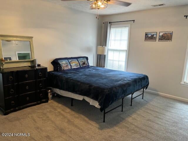 carpeted bedroom with ceiling fan