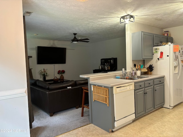 kitchen with gray cabinetry, sink, a textured ceiling, white appliances, and ceiling fan