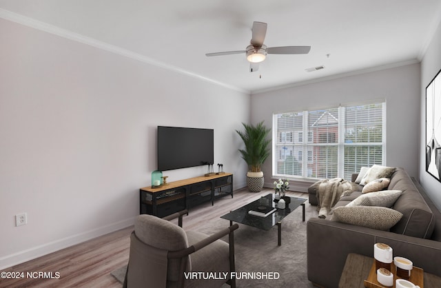 living room with crown molding, ceiling fan, and hardwood / wood-style flooring