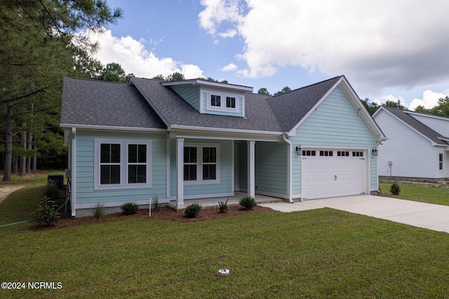 view of front of property with a front yard, a porch, and a garage