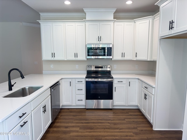 kitchen featuring stainless steel appliances, ornamental molding, sink, white cabinetry, and dark hardwood / wood-style flooring