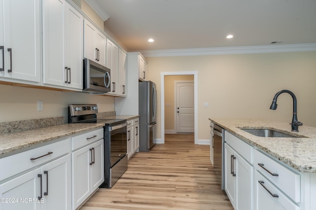 kitchen featuring white cabinets, stainless steel appliances, and a sink