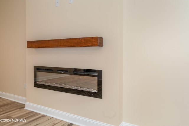 room details featuring baseboards and wood finished floors