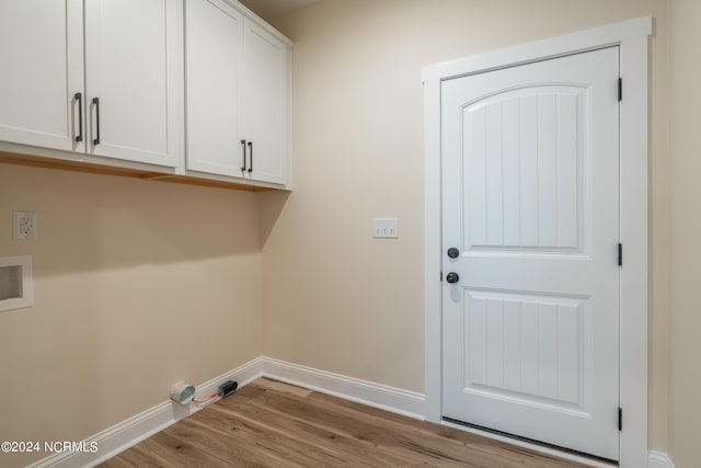 laundry area featuring washer hookup, light wood-type flooring, cabinet space, and baseboards