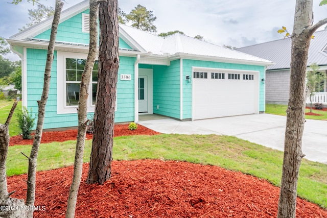 ranch-style house with a garage and driveway